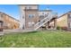 Back of house with deck, stairs, and landscaped yard at 6918 S Riverwood Way, Aurora, CO 80016