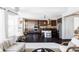 Modern kitchen with dark wood cabinets, island, and stainless steel appliances at 6918 S Riverwood Way, Aurora, CO 80016