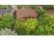 This is an aerial view showcasing the property's backyard, deck, mature trees and the brickwork of the house at 7077 Dudley Dr, Arvada, CO 80004