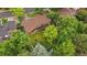 Bird's eye view of the home with a lush green lawn, mature trees and a wood deck and brick house at 7077 Dudley Dr, Arvada, CO 80004