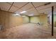 Spacious basement featuring carpeted floors and wood paneling at 7077 Dudley Dr, Arvada, CO 80004