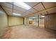 Basement featuring carpeted floors, wood paneling, and a built-in bar area at 7077 Dudley Dr, Arvada, CO 80004