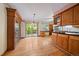 Open dining area with classic wood cabinets, hardwood floors, and access to an outdoor deck at 7077 Dudley Dr, Arvada, CO 80004