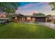 Charming brick home with a well-manicured lawn and a two-car garage offers great curb appeal at 7077 Dudley Dr, Arvada, CO 80004