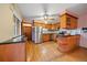 Functional kitchen with classic cabinets, stainless steel appliances, and a unique island with seating at 7077 Dudley Dr, Arvada, CO 80004