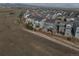 View of gray homes in a community, showcasing the neighborhood layout and mountain views in the distance at 15076 W 93Rd Ave, Arvada, CO 80007