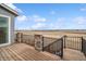 Wood deck with stone supports, dark metal railings and a view of the surrounding landscape at 15076 W 93Rd Ave, Arvada, CO 80007