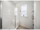 Shower stall with glass door, white tile, and a built-in bench with a window at 15076 W 93Rd Ave, Arvada, CO 80007