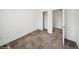 An empty bedroom with soft carpet and an open closet at 15076 W 93Rd Ave, Arvada, CO 80007