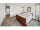 A cozy bedroom featuring a wood sleigh bed, plush carpet, and natural light at 15076 W 93Rd Ave, Arvada, CO 80007