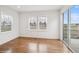 Bright bedroom with wood flooring, large windows, and a sliding glass door that provides outdoor access at 15076 W 93Rd Ave, Arvada, CO 80007