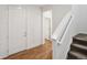 Welcoming foyer featuring wood-look floors and a staircase with white banisters at 15076 W 93Rd Ave, Arvada, CO 80007