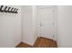 Bright entryway with a coat rack and a white paneled door set against a light-colored wall at 15076 W 93Rd Ave, Arvada, CO 80007