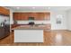 Spacious kitchen featuring wood cabinets, granite countertops, stainless steel appliances, and a large center island at 15076 W 93Rd Ave, Arvada, CO 80007