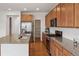 Modern kitchen featuring granite countertops, stainless steel appliances, and ample cabinet space, with a large pantry at 15076 W 93Rd Ave, Arvada, CO 80007