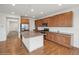 Open kitchen with wood cabinets, granite countertops, stainless steel appliances, and large island perfect for gatherings at 15076 W 93Rd Ave, Arvada, CO 80007