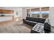 Open-concept living room showcasing a modern kitchen, adjacent to living space with large windows at 15076 W 93Rd Ave, Arvada, CO 80007