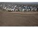 An aerial view reveals an extensive residential neighborhood with rows of uniform houses at 15076 W 93Rd Ave, Arvada, CO 80007