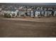 Aerial view of a sprawling neighborhood nestled amidst open fields and scenic surroundings at 15076 W 93Rd Ave, Arvada, CO 80007