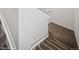 Carpeted staircase with white trim and a neutral colored carpet at 15076 W 93Rd Ave, Arvada, CO 80007