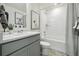 Bright bathroom featuring vanity with framed mirror, a sink, and a shower-tub combination with artwork at 1356 S Boston Ct # B, Denver, CO 80247