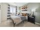 Comfortable bedroom with modern decor, soft lighting, and a large window providing ample natural light at 1356 S Boston Ct # B, Denver, CO 80247