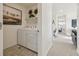 Convenient laundry room equipped with modern washer and dryer, and shelving for ample storage at 1356 S Boston Ct # B, Denver, CO 80247