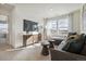 Cozy living room with plush gray sofa, modern decor, and sun-drenched windows overlooking neighborhood at 1356 S Boston Ct # B, Denver, CO 80247
