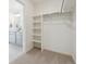 Organized walk-in closet with adjustable shelving, next to a bathroom featuring a double vanity at 1356 S Boston Ct # B, Denver, CO 80247