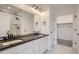 Stylish bathroom with double vanity, marble floors, and walk-in shower at 2491 W 69Th Pl, Denver, CO 80221