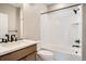 Bathroom featuring a tub-shower combo with black hardware and a light wood vanity at 2491 W 69Th Pl, Denver, CO 80221