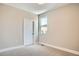 Bedroom with neutral carpet and paint and a window providing natural light and neighborhood views at 2491 W 69Th Pl, Denver, CO 80221
