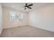 Bright bedroom featuring neutral carpeting, large windows, and a ceiling fan at 2491 W 69Th Pl, Denver, CO 80221