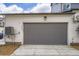 Exterior shot of a two car garage with a gray door and off-white siding at 2491 W 69Th Pl, Denver, CO 80221
