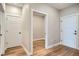 Hallway showcasing natural wood flooring and clean white door frames at 2491 W 69Th Pl, Denver, CO 80221