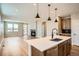 Open kitchen with stainless appliances and a view into the living room with a fireplace at 2491 W 69Th Pl, Denver, CO 80221