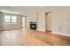 Open living area featuring hardwood floors, fireplace, and modern door at 2491 W 69Th Pl, Denver, CO 80221