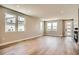 Bright open-concept living room with hardwood floors and large windows offering ample natural light at 2491 W 69Th Pl, Denver, CO 80221