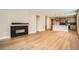 Spacious living room featuring a fireplace, hardwood floors, and open access to the kitchen at 2491 W 69Th Pl, Denver, CO 80221