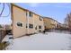 Backyard with snow, wooden fence, and house at 4821 N Silverlace Dr, Castle Rock, CO 80109