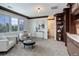 Comfortable bonus room with cozy seating, natural light, and a built-in bookcase for added charm at 6724 S Yates Ct, Littleton, CO 80128