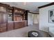 Bonus room featuring a built-in bookcase, an open layout, and soft carpeting for added comfort at 6724 S Yates Ct, Littleton, CO 80128