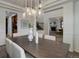 Dining room with modern chandelier, views to the living room and kitchen at 6724 S Yates Ct, Littleton, CO 80128
