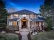 Charming home with stone accents, a welcoming front porch, and a professionally landscaped yard at 6724 S Yates Ct, Littleton, CO 80128