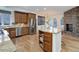 Gourmet kitchen features stainless steel appliances, granite countertops, kitchen island, and a stone fireplace at 6724 S Yates Ct, Littleton, CO 80128