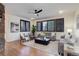 Bright living room with hardwood floors, fireplace, and large windows with plantation shutters at 6724 S Yates Ct, Littleton, CO 80128
