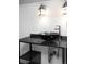 Modern bathroom features a black vessel sink, chrome faucet, and stylish industrial light fixtures at 7680 Elmwood St, Littleton, CO 80125