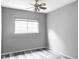 A serene bedroom featuring stylish flooring, neutral walls, and a bright window for natural light at 7680 Elmwood St, Littleton, CO 80125