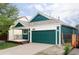 Home featuring a lovely porch and two-car garage, with a well-maintained driveway at 7680 Elmwood St, Littleton, CO 80125