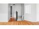 Spacious hallway with hardwood floors, offering a view of the stairs to lower level at 7680 Elmwood St, Littleton, CO 80125